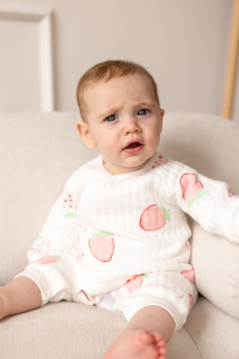 Front view of baby wearing the Strawberry Bouclé Wrap Baby Grow Romper