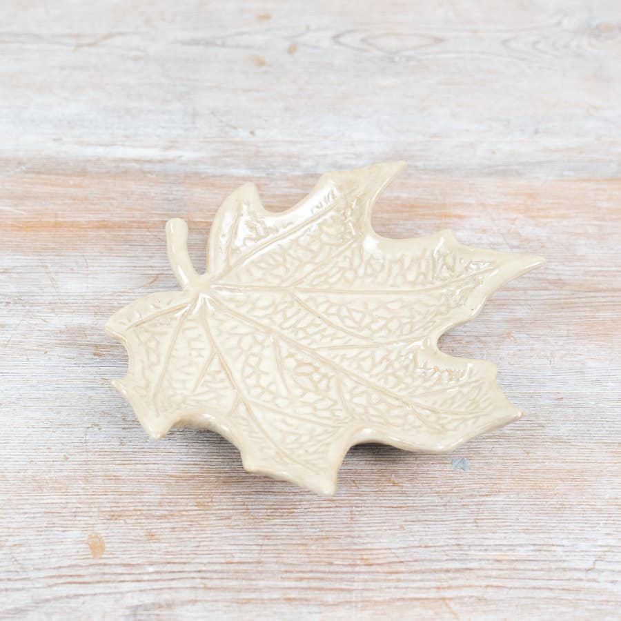 Cream leaf-shaped trinket dish with detailed textured surface and glossy finish