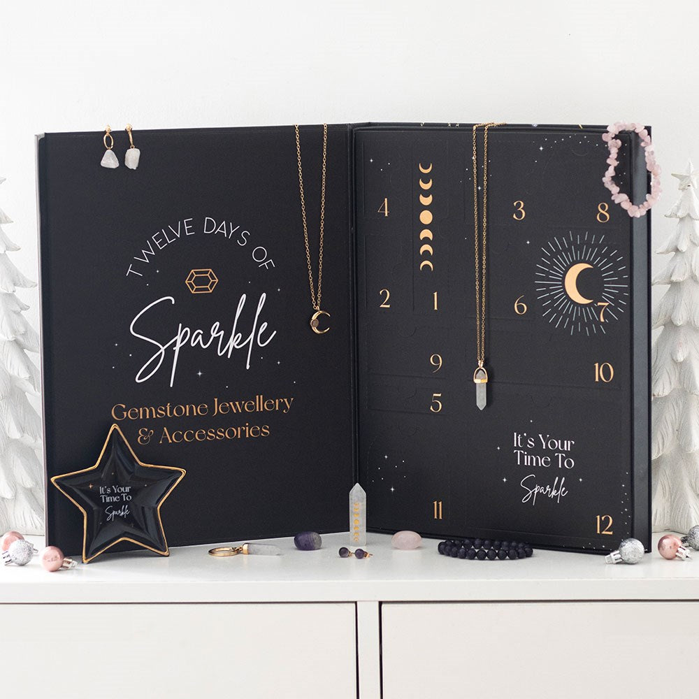 12-Day Crystal Jewellery Advent Calendar displayed open with gemstone necklaces, bracelets and crystals arranged around it