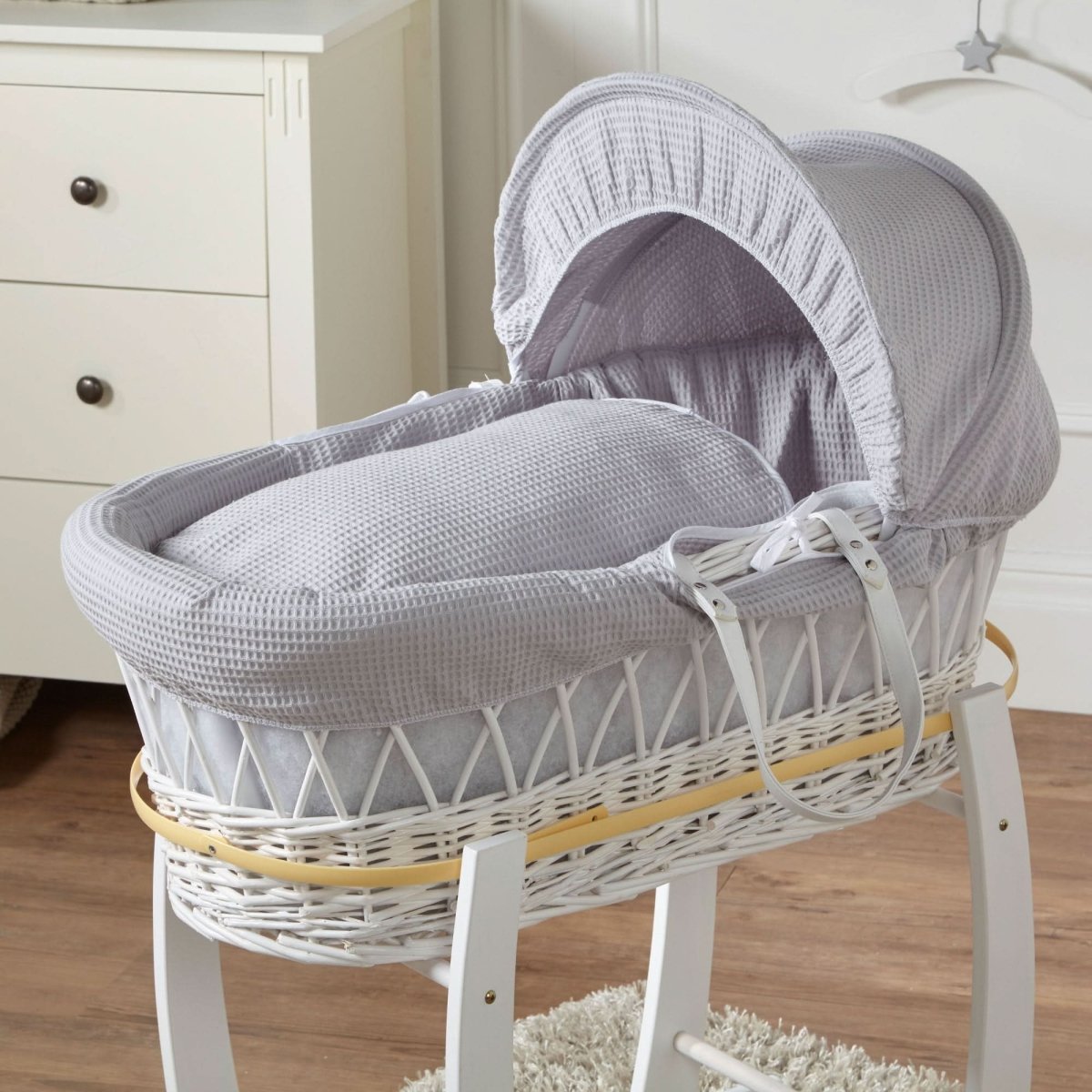 Grey Waffle White Wicker Baby Moses Basket shown with coordinating grey bedding and white wooden stand