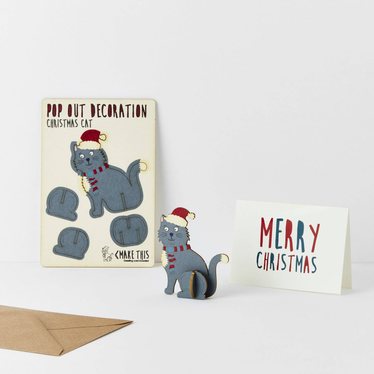 Pop Out Cat Christmas Card showing the pop-out sheet, assembled festive cat, greeting card and brown envelope