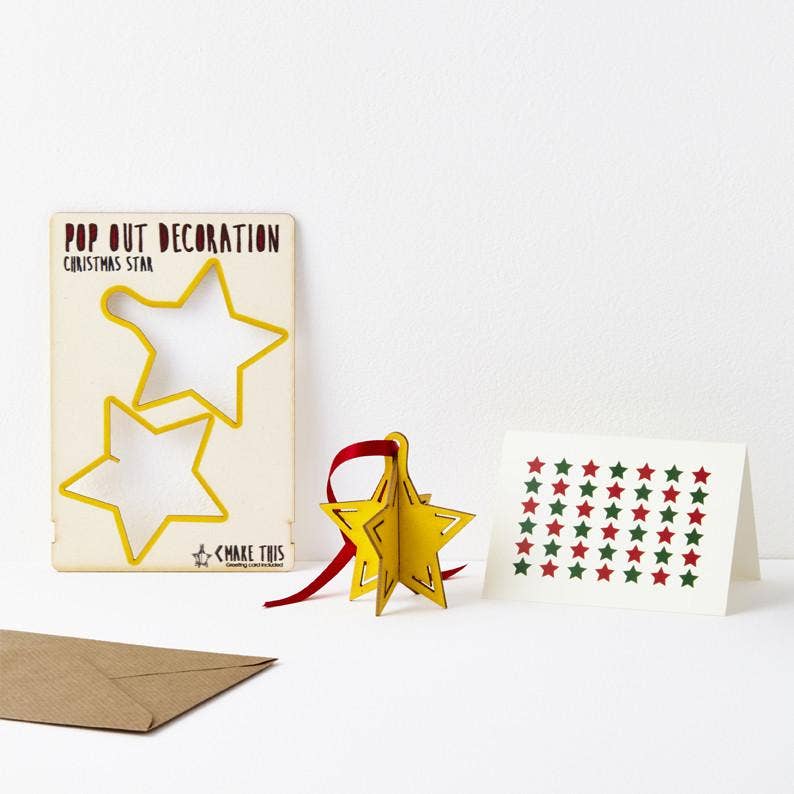 Pop Out Star Christmas Card showing the pop-out sheet, assembled wooden star, red ribbon and patterned greeting card