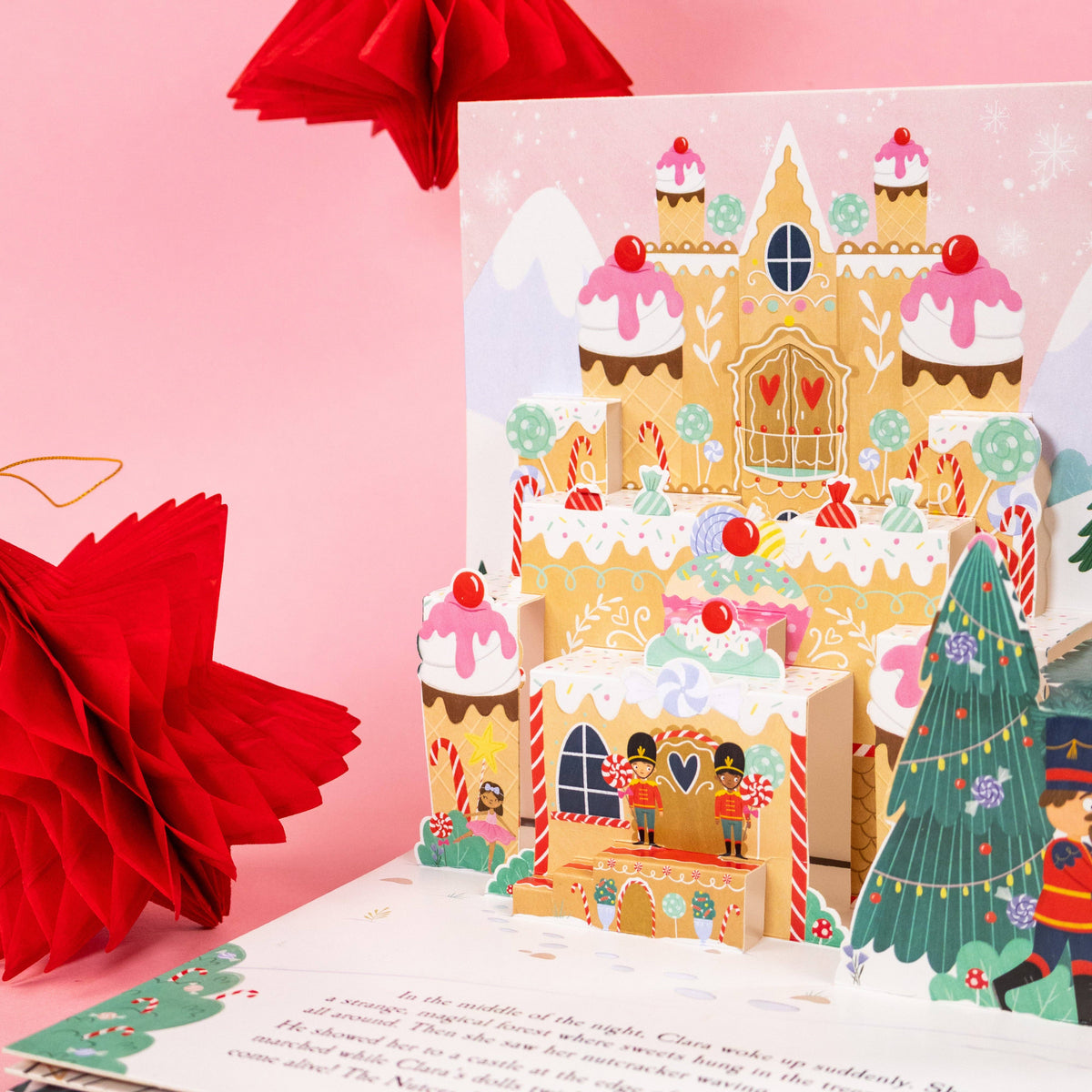 The Nutcracker children's pop-up book showing a colourful three-dimensional Christmas scene against a pink background