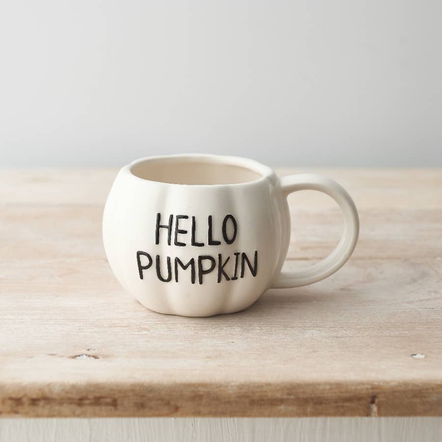 White ceramic pumpkin-shaped mug embossed with Hello Pumpkin