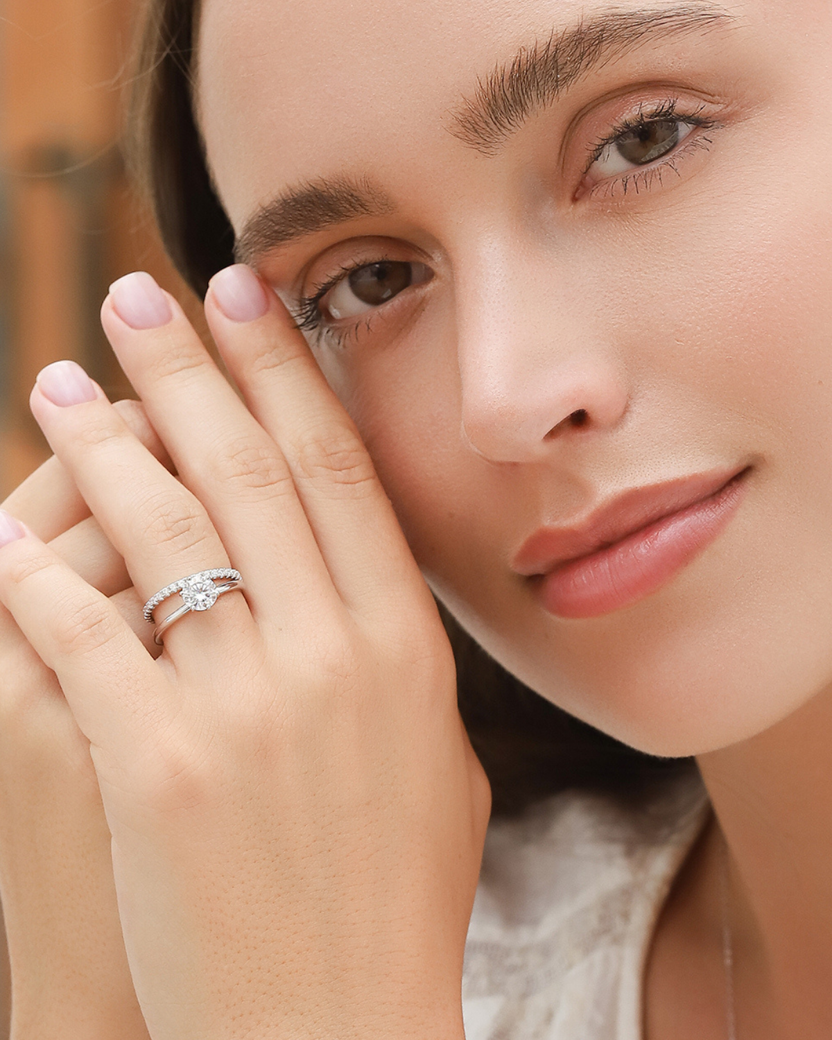 1ct round solitaire moissanite engagement ring worn on the hand, showing its elegant proportions and classic setting.