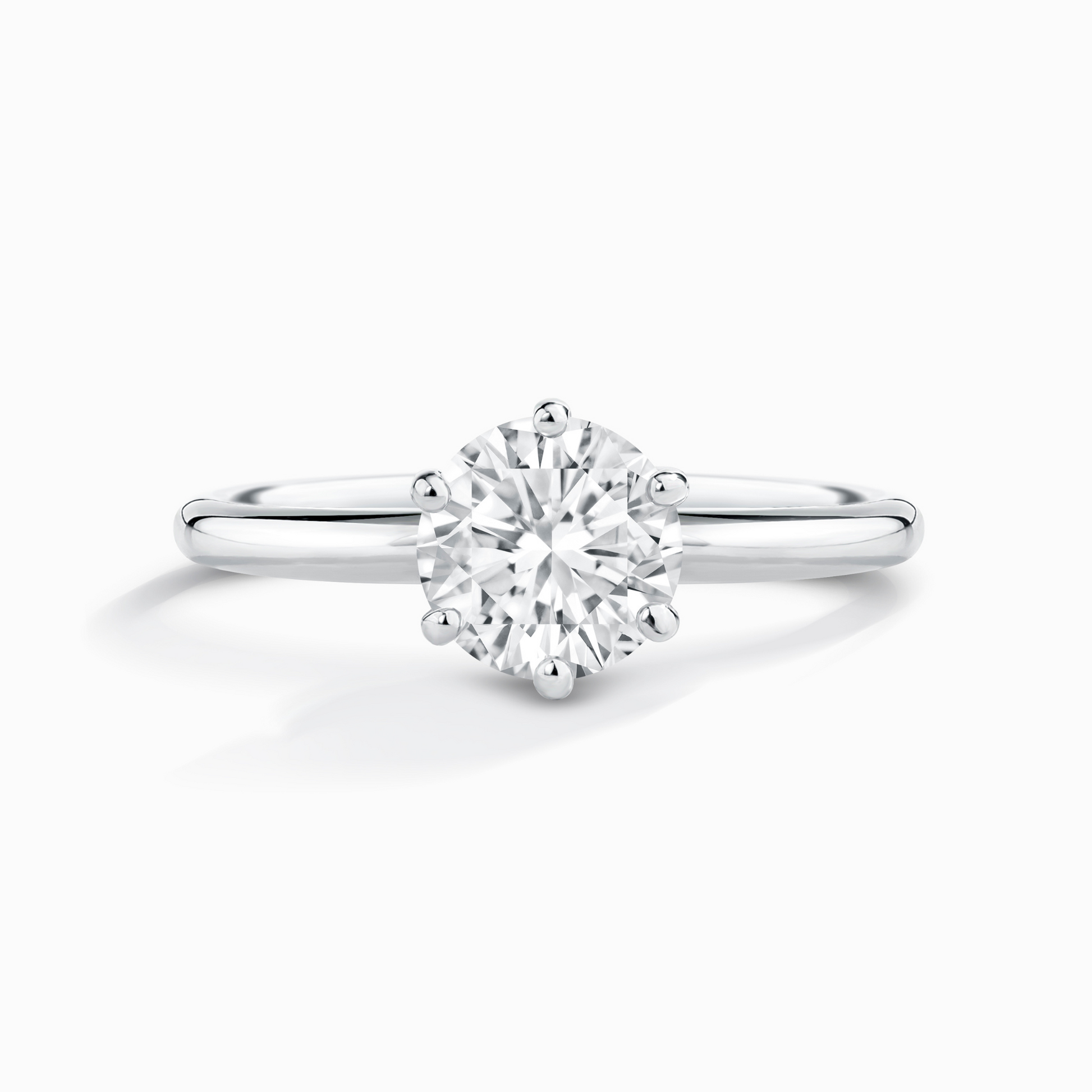 1ct round solitaire moissanite engagement ring in rhodium-plated sterling silver with a classic plain band.