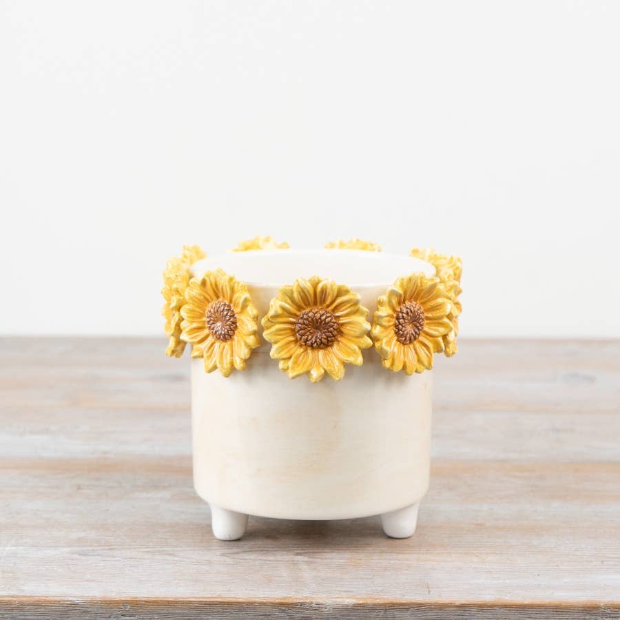 Cream plant pot with raised yellow sunflower decoration and footed base