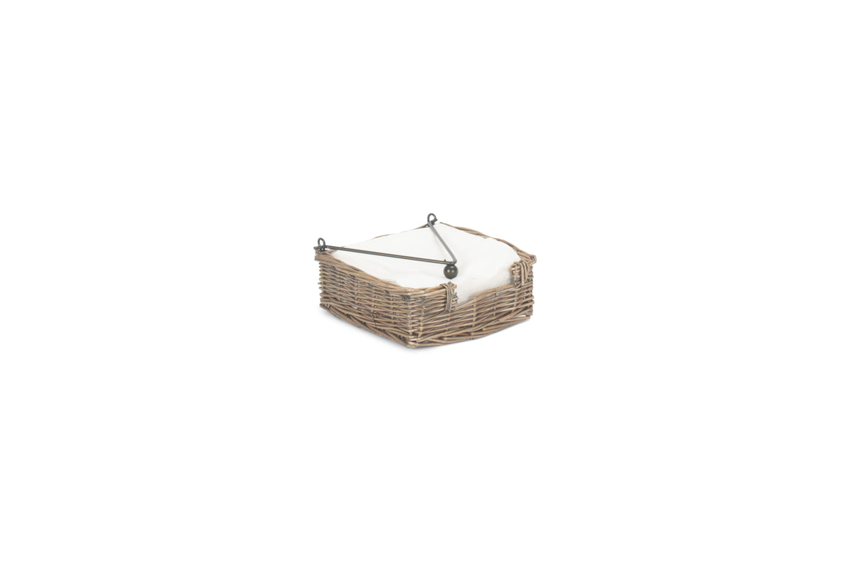 Antique Wash Willow Napkin Holder filled with white napkins and secured by the hinged metal weight
