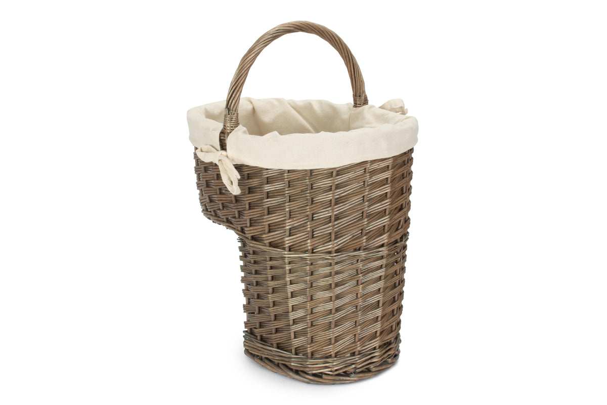 Antique wash willow stair basket with cream cotton lining, integral carry handle and stepped storage design