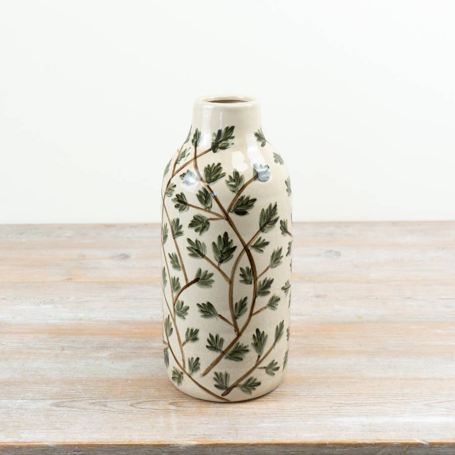 Cream ceramic foliage vase with trailing green leaves and brown stems, 30.5cm high