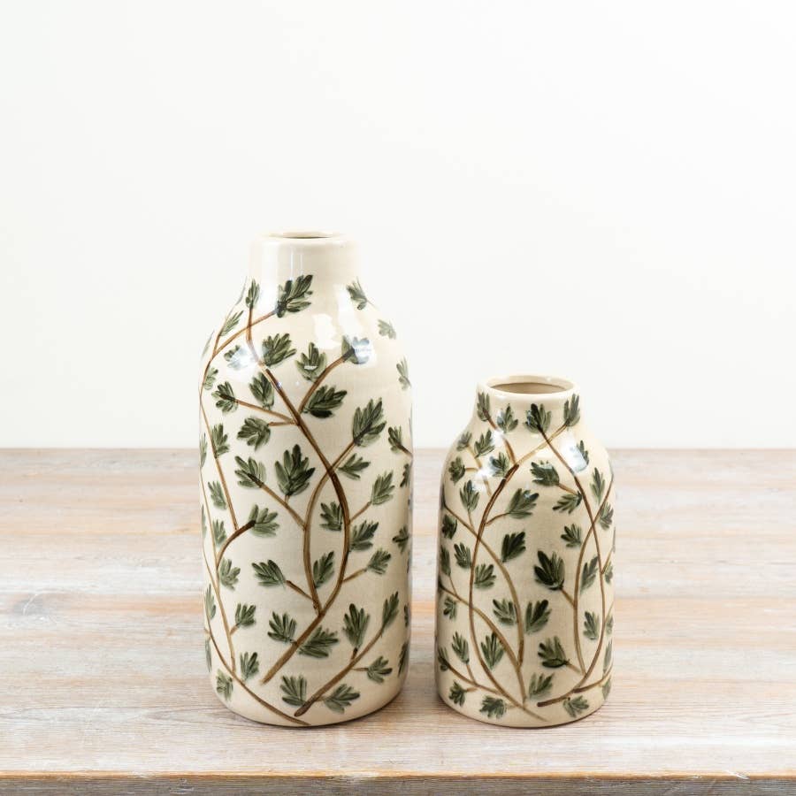 Foliage ceramic vase displayed alongside coordinating cream ceramic vases with leafy botanical designs