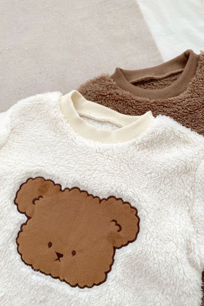 Close-up of the bear motif on the Creme Love Fur Bear Knitted Hooded Pramsuit