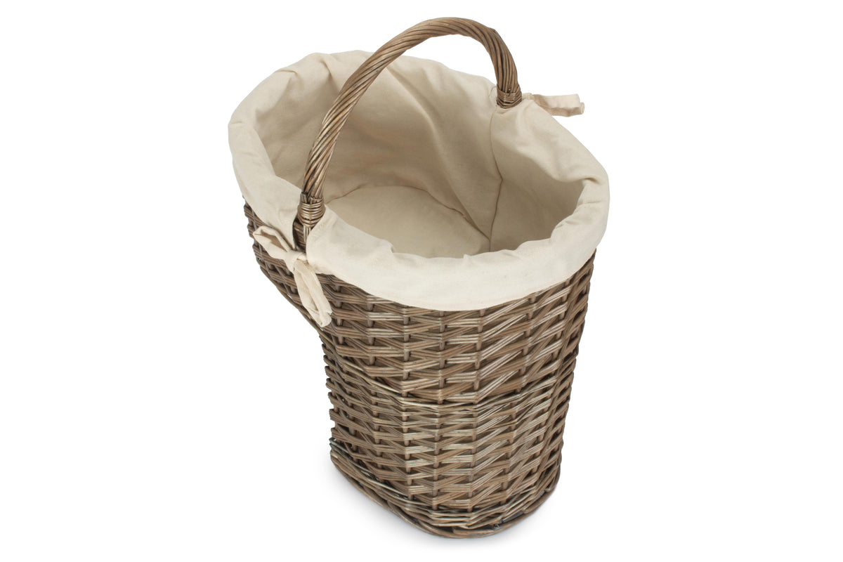 Antique wash willow stair basket viewed from above showing the cream cotton lined interior and carry handle