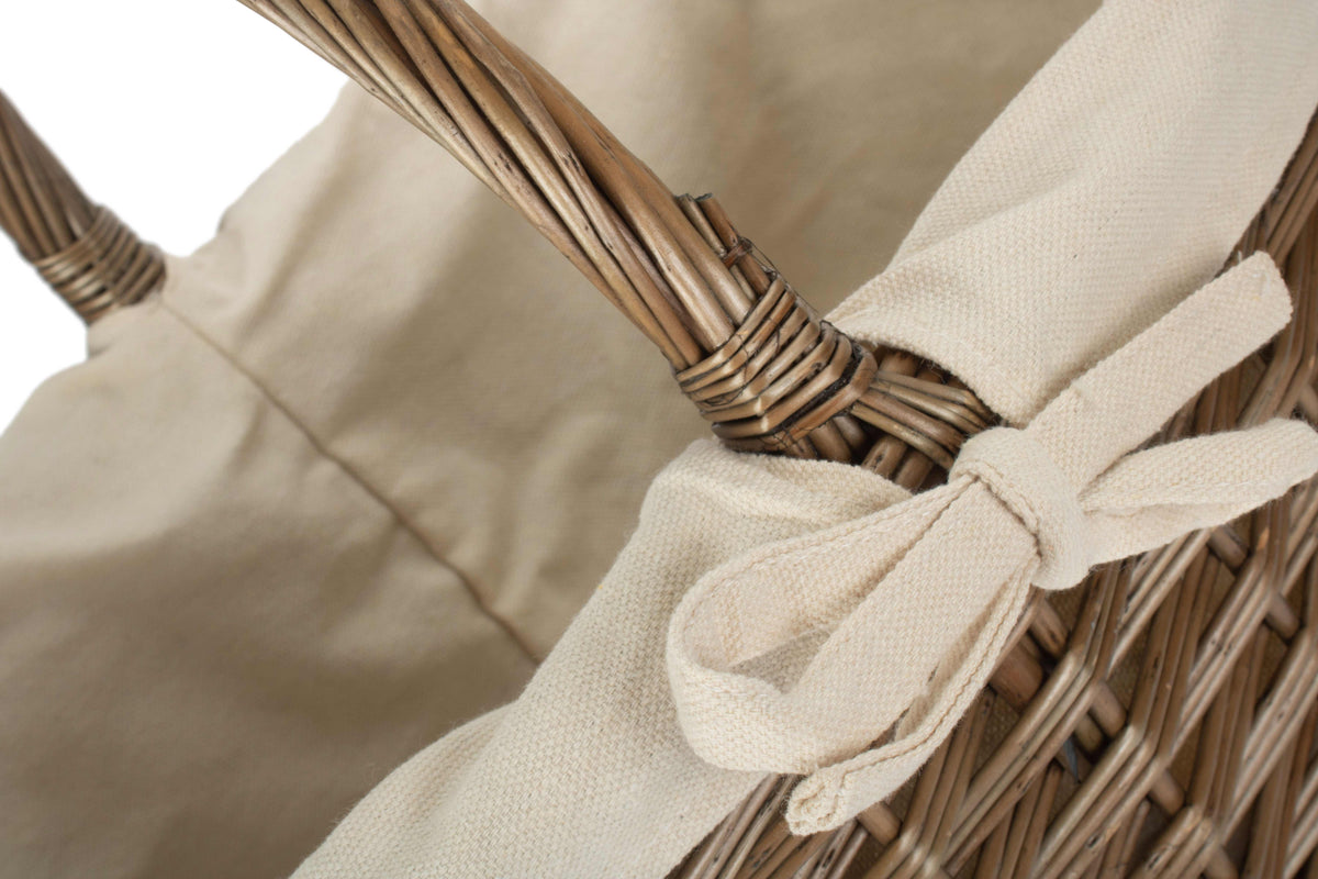 Close-up of antique wash willow stair basket showing the woven willow construction and tied cream cotton lining