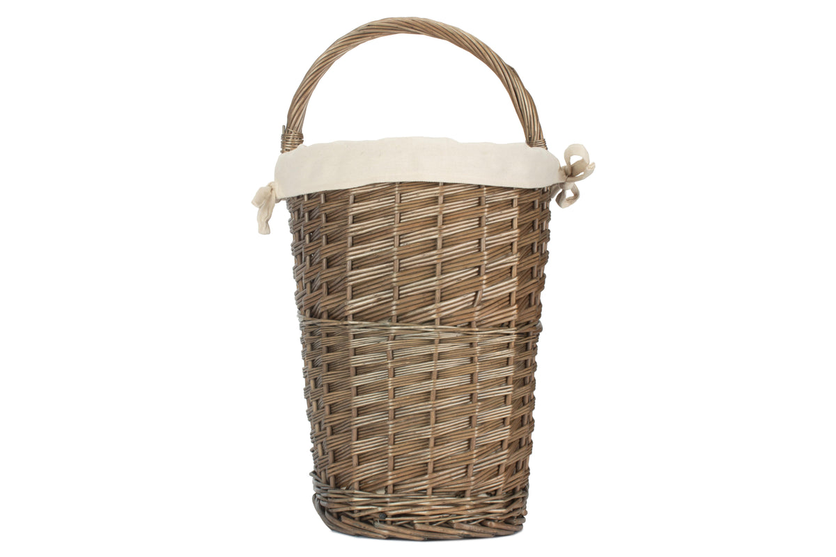 Rear view of antique wash willow stair basket with cream cotton lining and woven willow carry handle