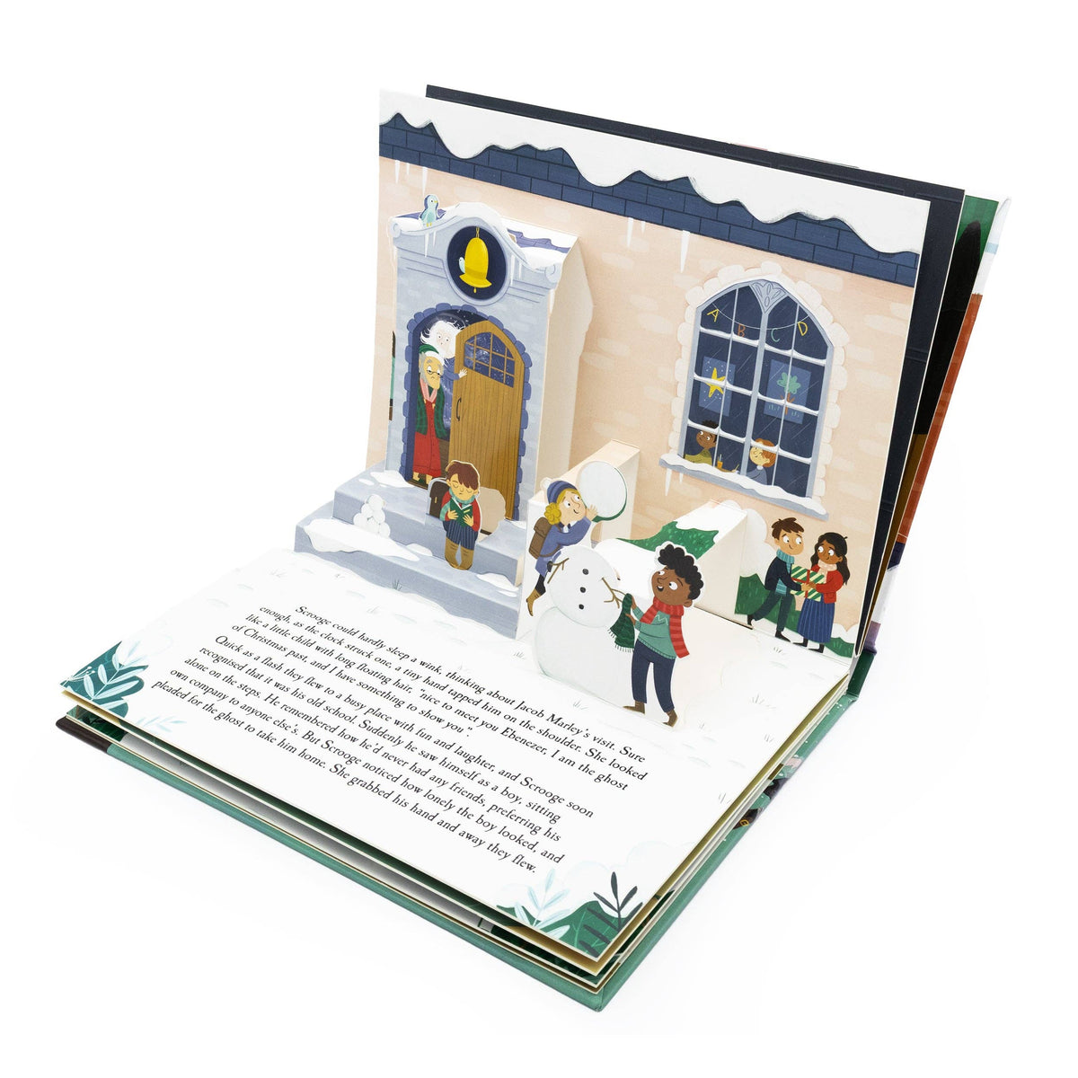 A Christmas Carol pop-up book opened to show a three-dimensional illustrated Christmas street scene