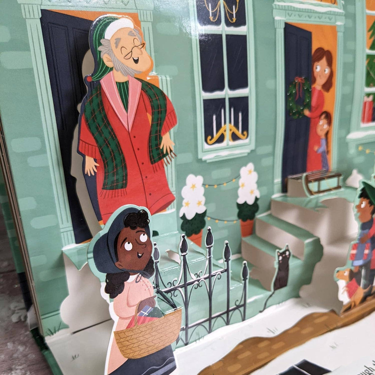A Christmas Carol pop-up book showing a close-up of its colourful three-dimensional illustrations featuring Scrooge