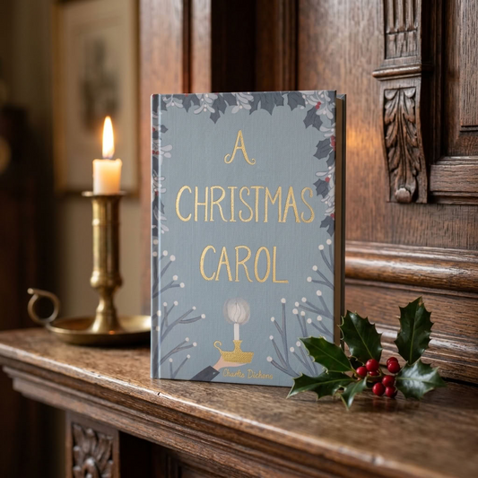A Christmas Carol by Charles Dickens Wordsworth hardback on a Victorian mantel with holly and candlelight
