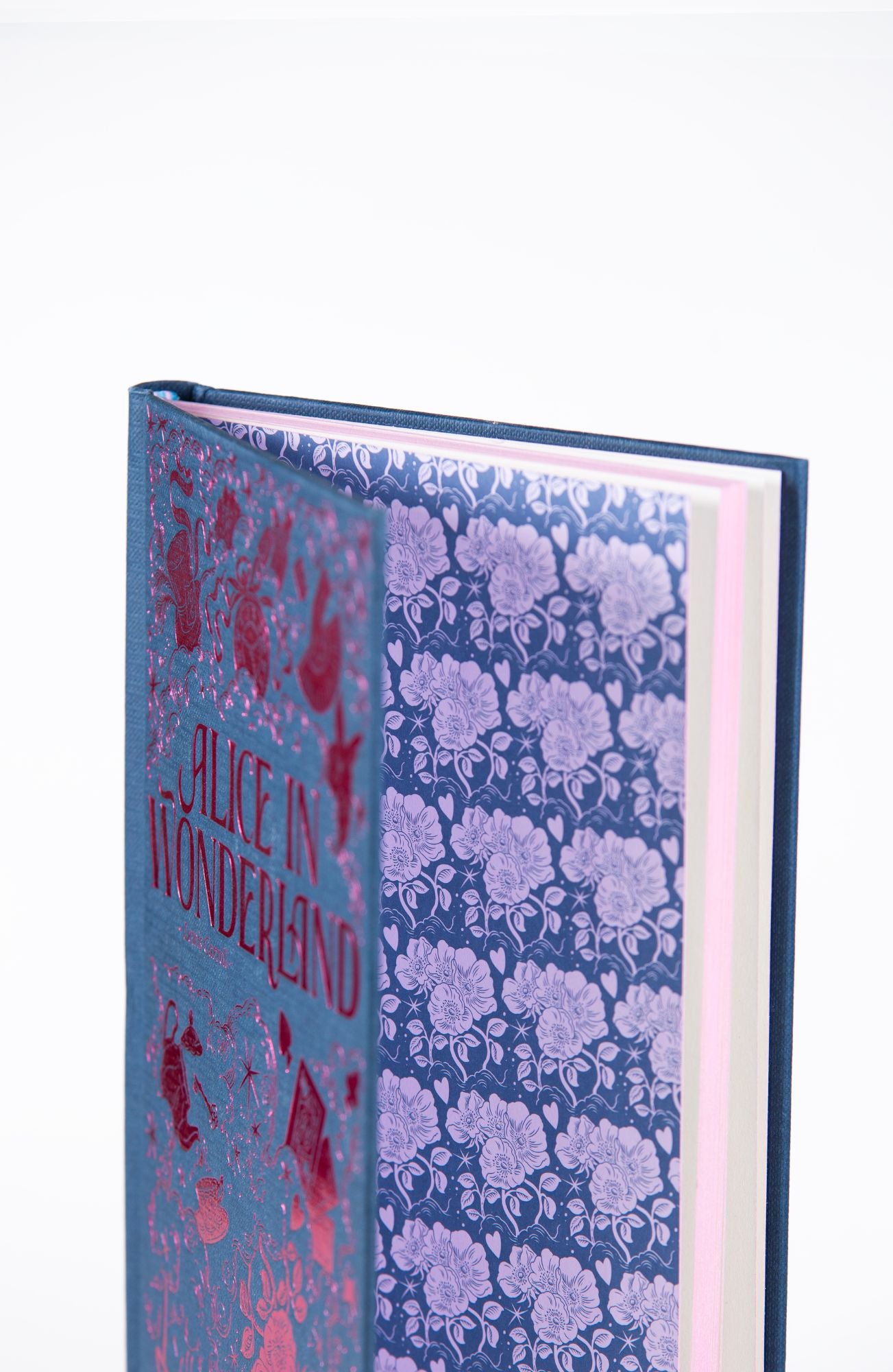 Alice in Wonderland Wordsworth Luxe Collection hardback open to show the decorative endpapers and premium interior design.