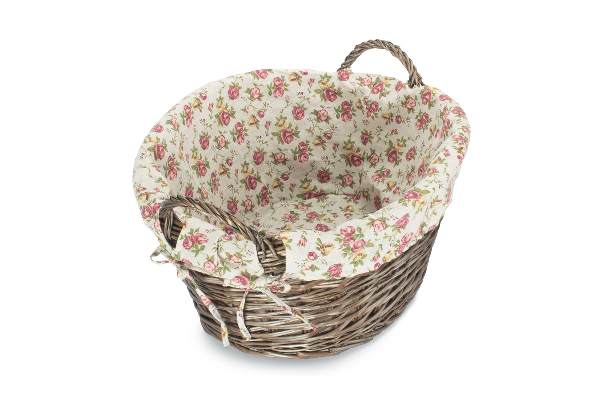 Antique Wash Willow Laundry Basket viewed from an angle showing the removable rose-patterned lining and woven willow construction