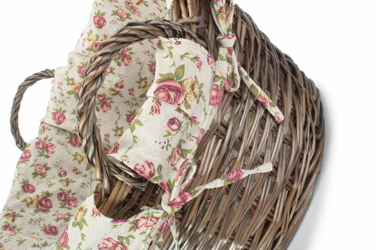 Antique Wash Willow Laundry Basket close-up showing the pink Garden Rose floral fabric lining and traditional woven willow rim