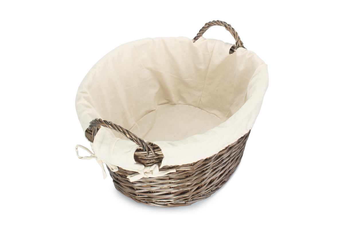 Antique wash willow laundry basket viewed from above showing the spacious interior and white fabric lining