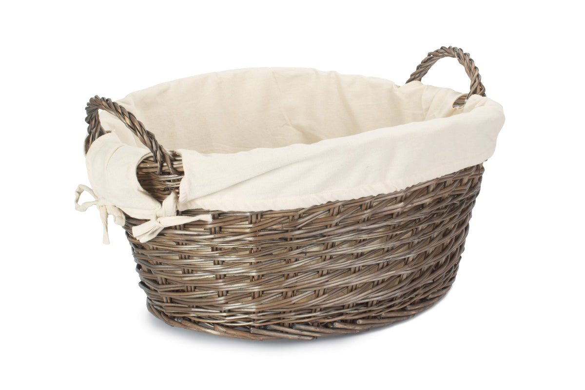 Antique wash willow laundry basket with white fabric lining, two woven handles and traditional oval shape