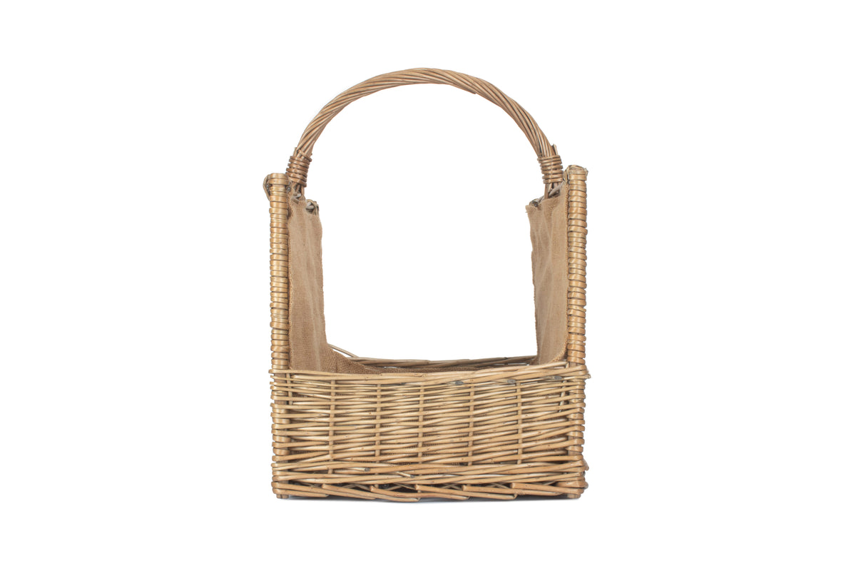 Antique wash willow open end log basket viewed from the front, showing its woven willow construction and arched handle