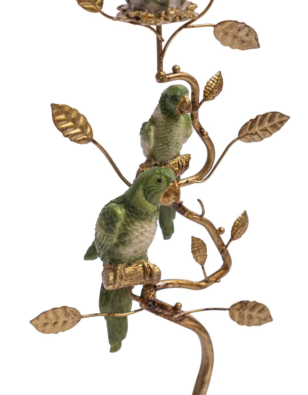 Close view of two green parrots perched on the ornate gold branch candle holder