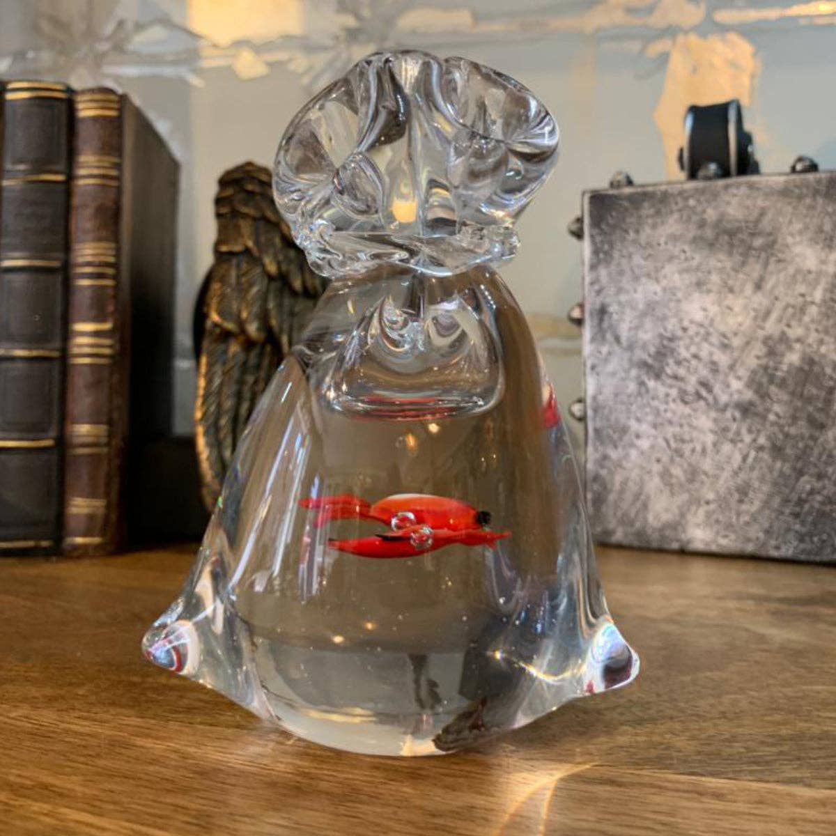 Bentley & Bo hand-blown glass bag paperweight with red goldfish displayed on a wooden surface