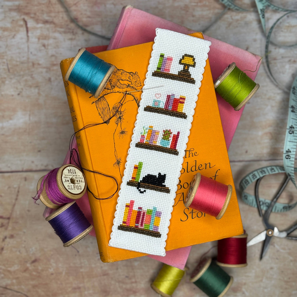 Book Lover Cross Stitch Bookmark Kit finished bookshelf bookmark styled with colourful books and sewing threads