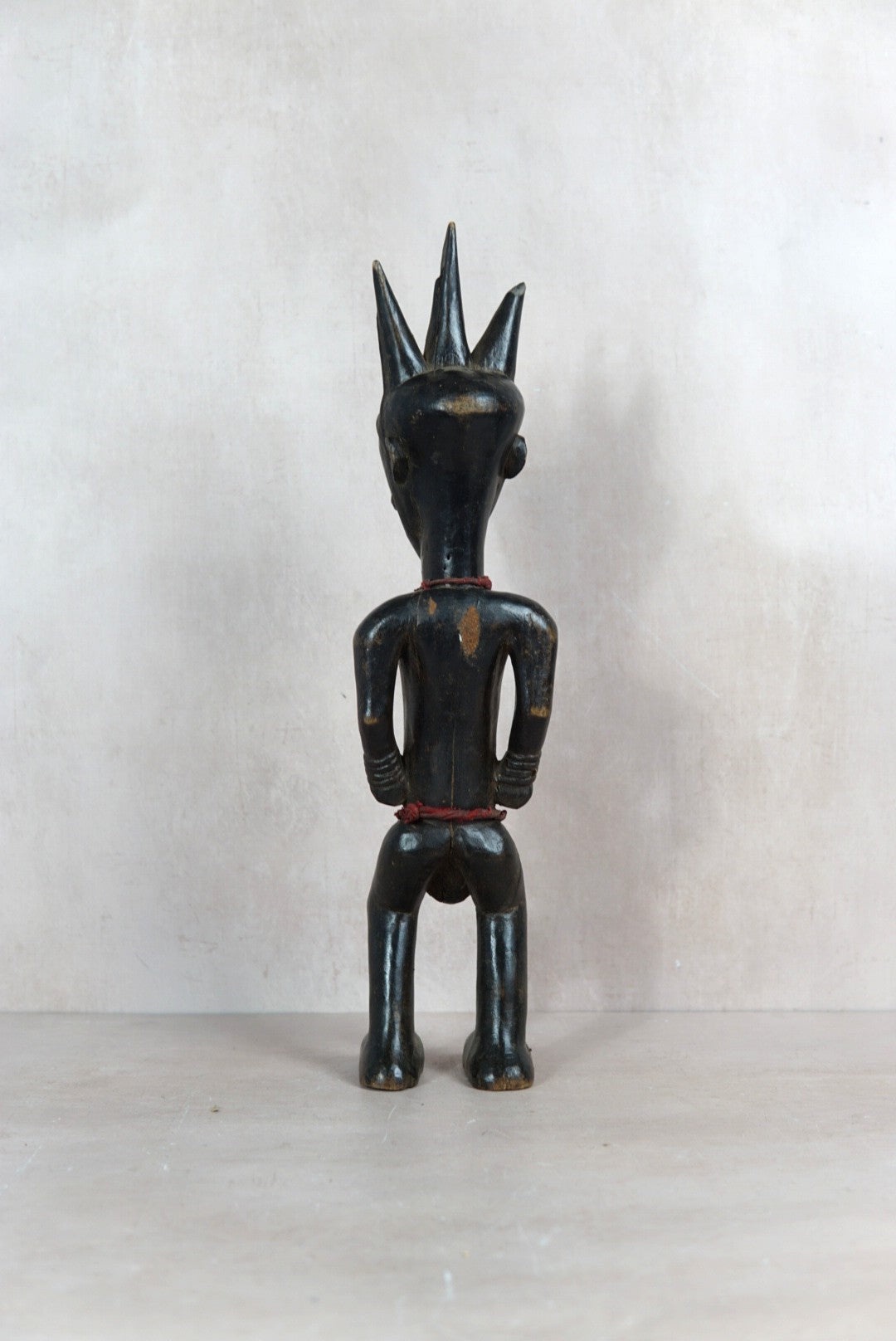 Baule carved figure sculpture 118.1 shown from the rear with traditional coiffure and scarification detailing
