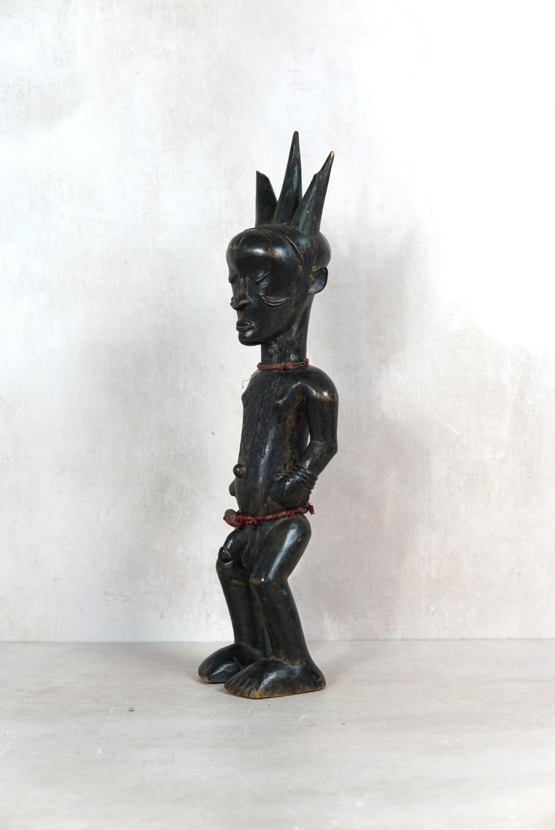 Baule carved male figure sculpture 118.1 in side view showing its dark patina and sculptural profile

