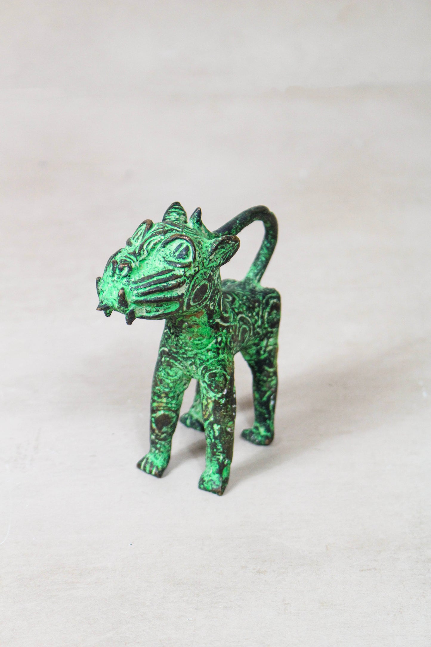 Benin bronze leopard sculpture 56.24 viewed from the front showing traditional cast detailing
