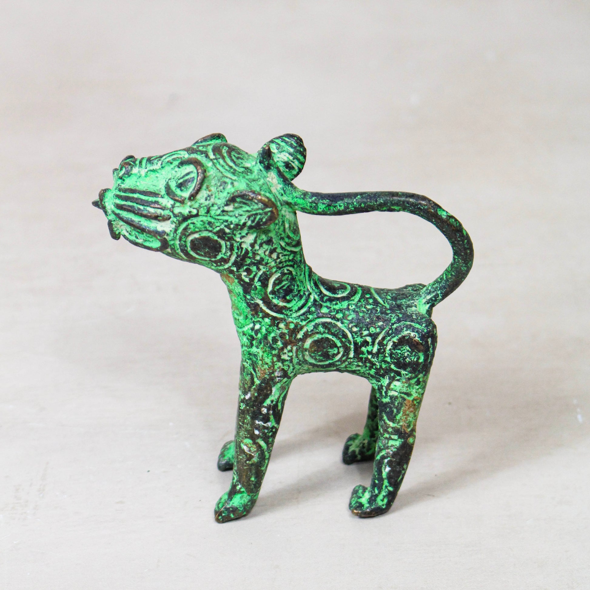 Benin bronze leopard sculpture 56.24 shown from the side, with aged green bronze finish
