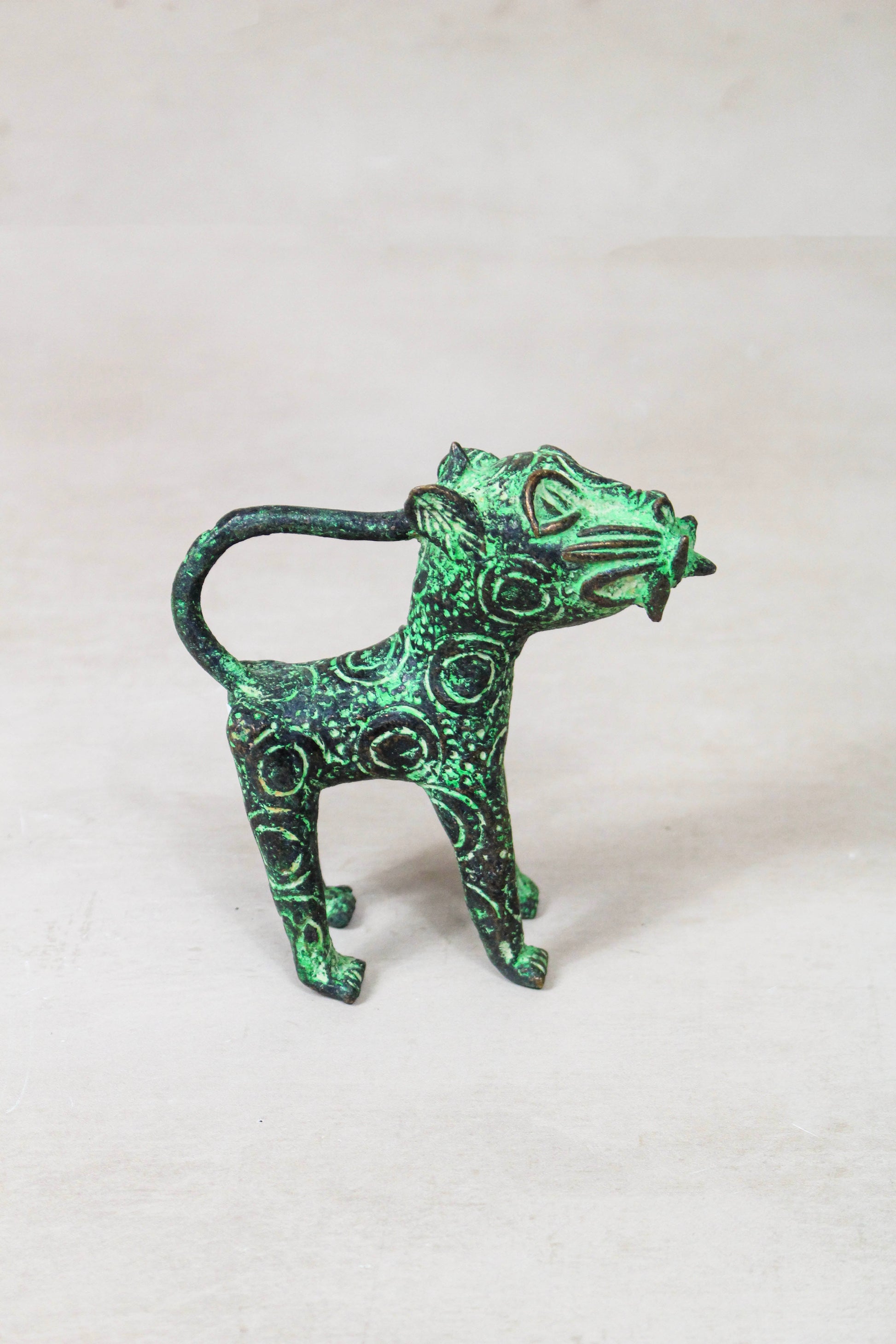 Benin bronze leopard sculpture 56.24 side view showing the elongated body and openwork detailing
