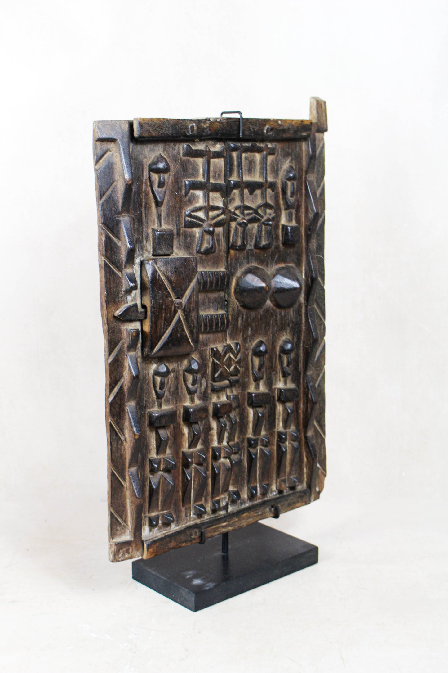 Dogon granary door from Mali 38.2 viewed at an angle showing the depth of the carved wooden surface
