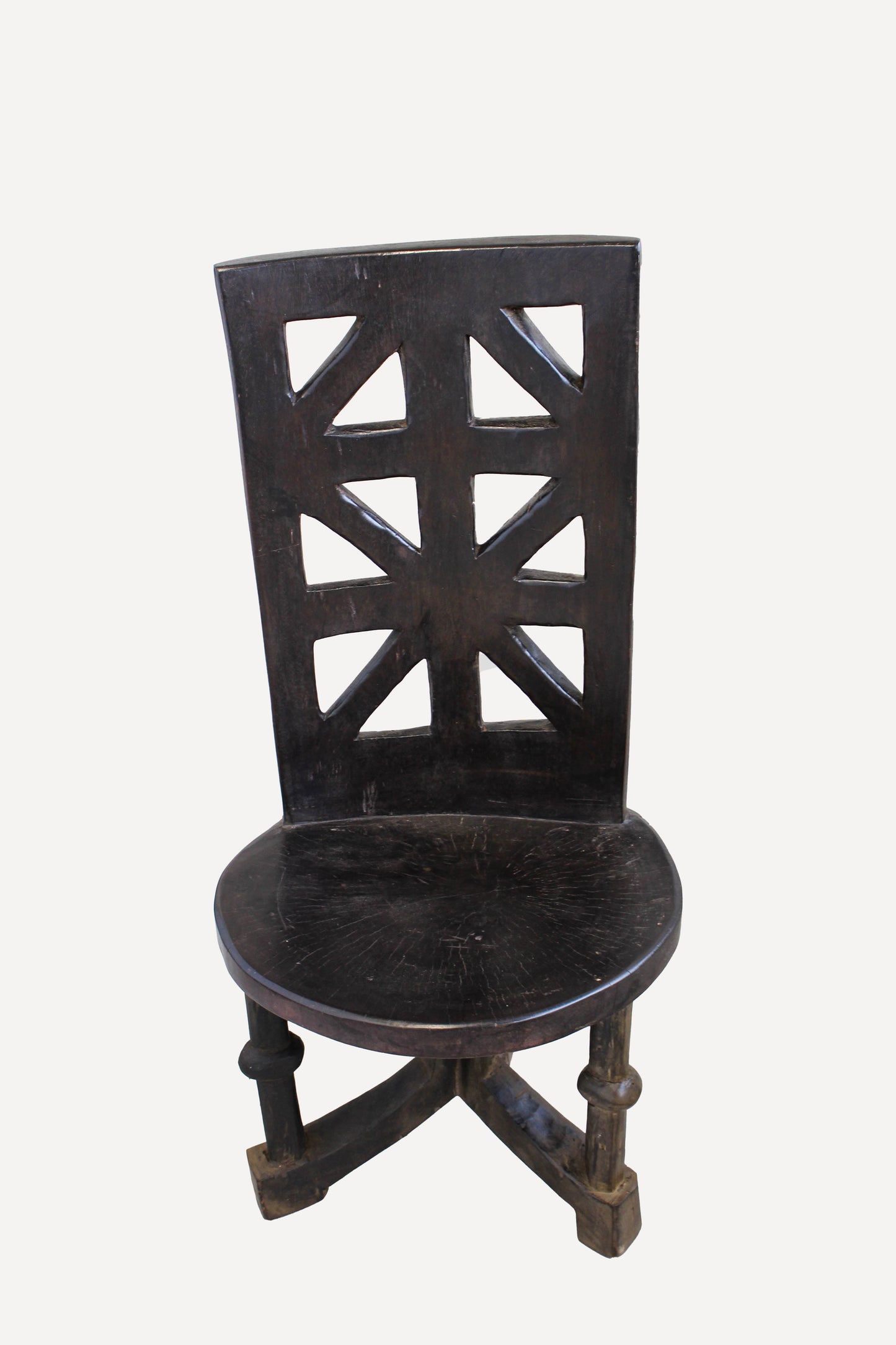 Hand-carved Makonde chair from Tanzania with tall incised backrest and sculpted ancestor figure

