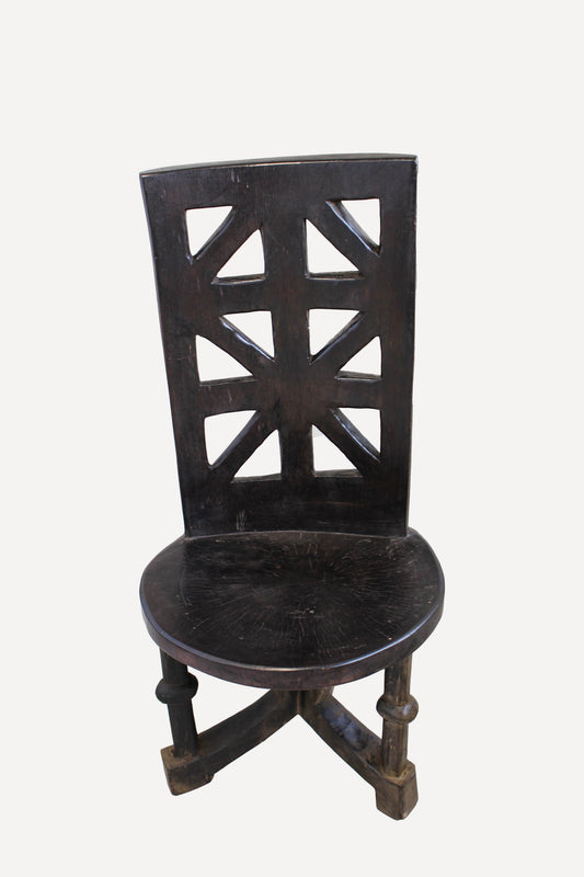 Hand-carved Makonde chair from Tanzania with tall incised backrest and sculpted ancestor figure
