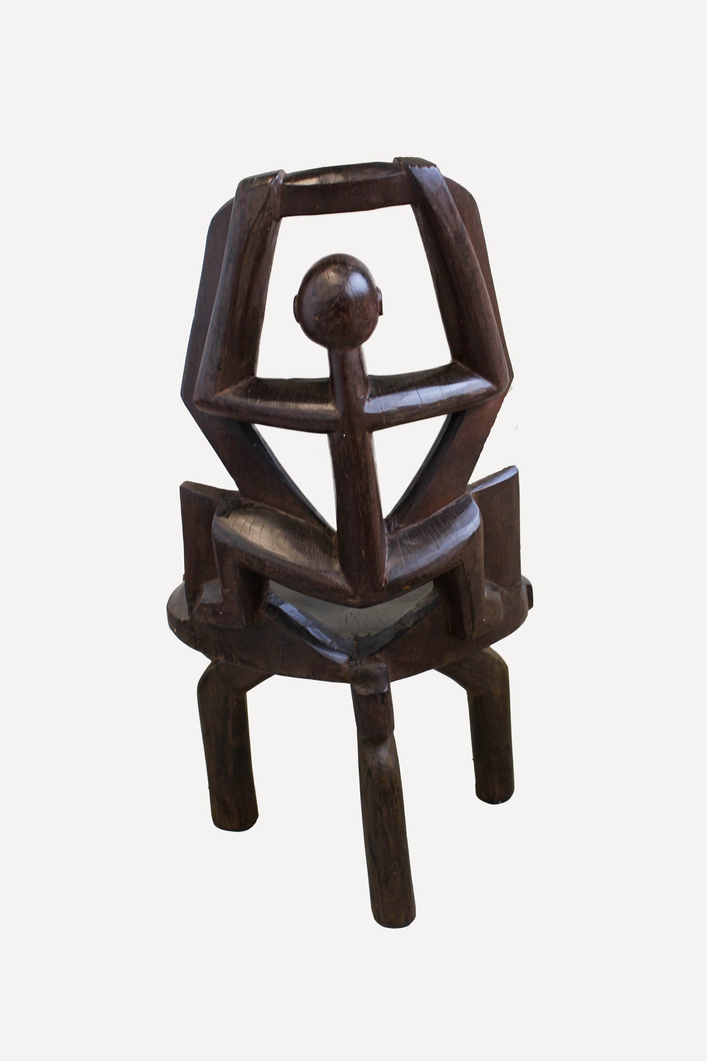 Hand-carved Makonde chair from Tanzania 242.4 showing the tall open backrest and traditional carved detailing
