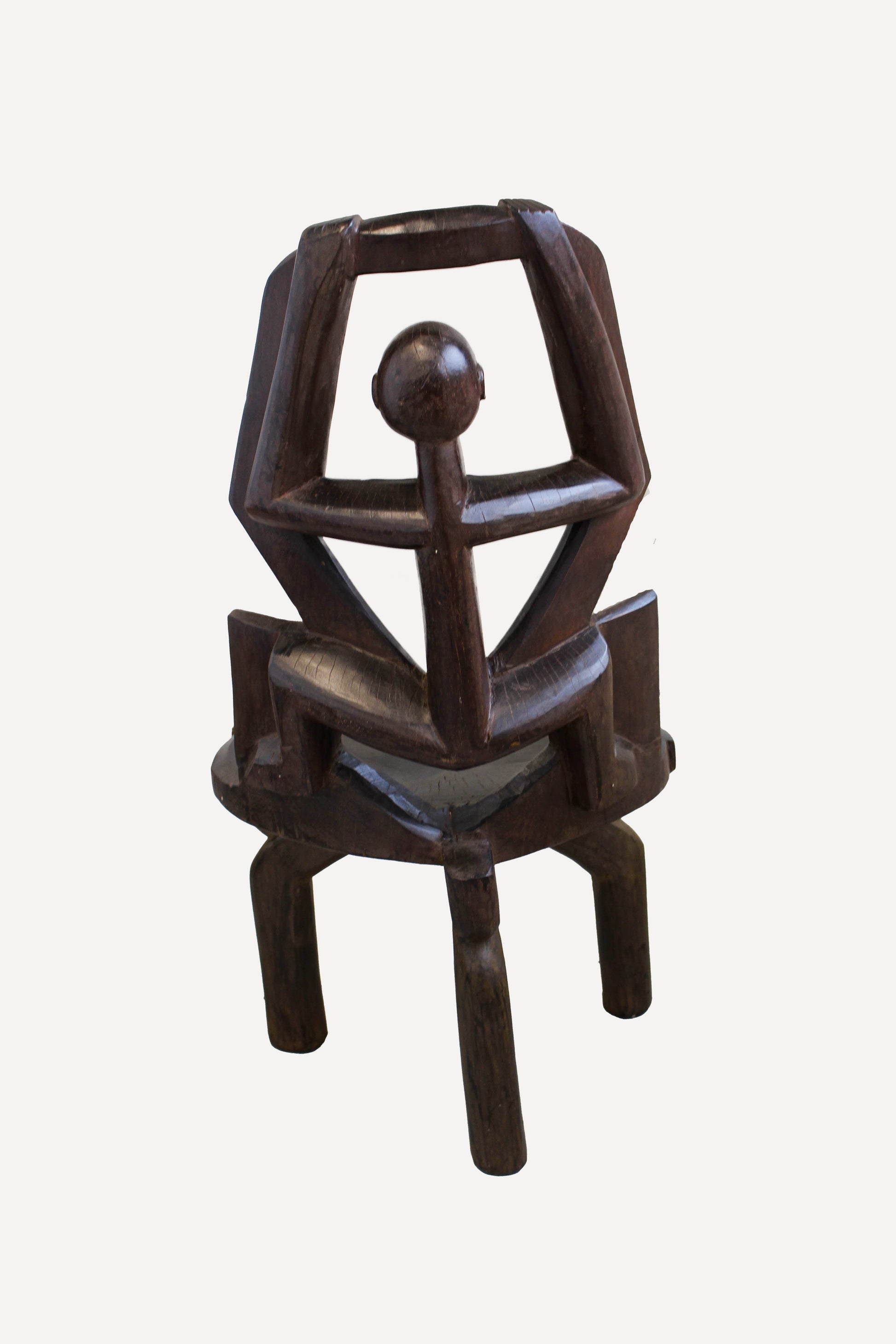 Hand-carved Makonde chair from Tanzania 242.4 showing the tall open backrest and traditional carved detailing
