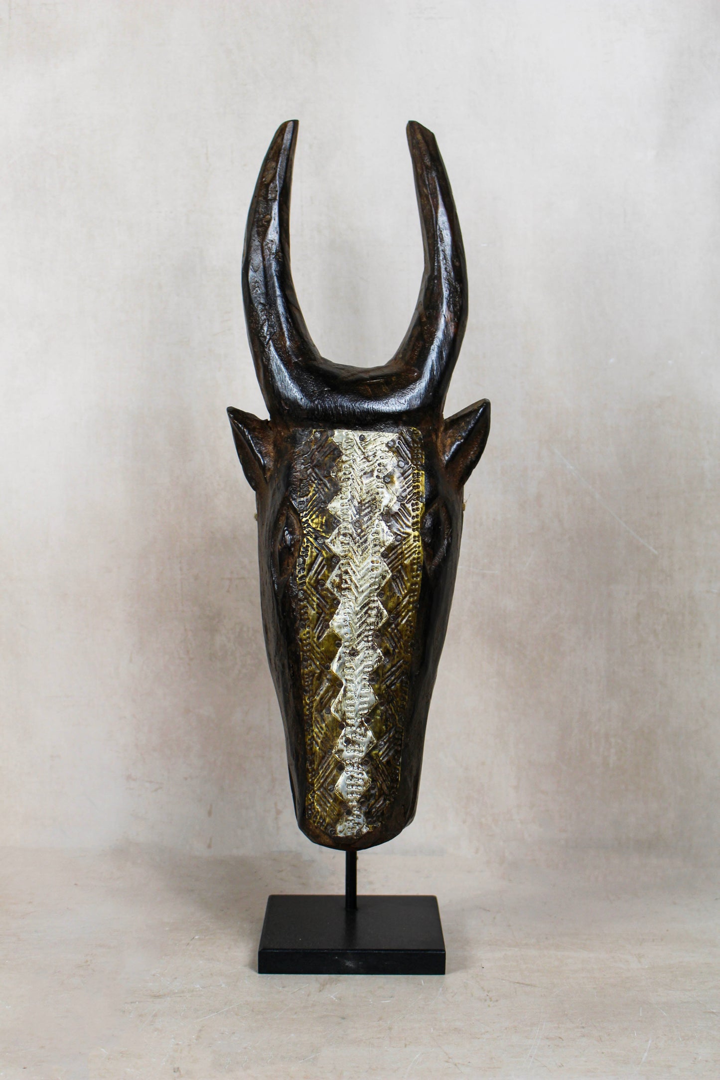 Mali bull mask 196.4 with upright horns, dark carved wood and hand-hammered repoussé metalwork
