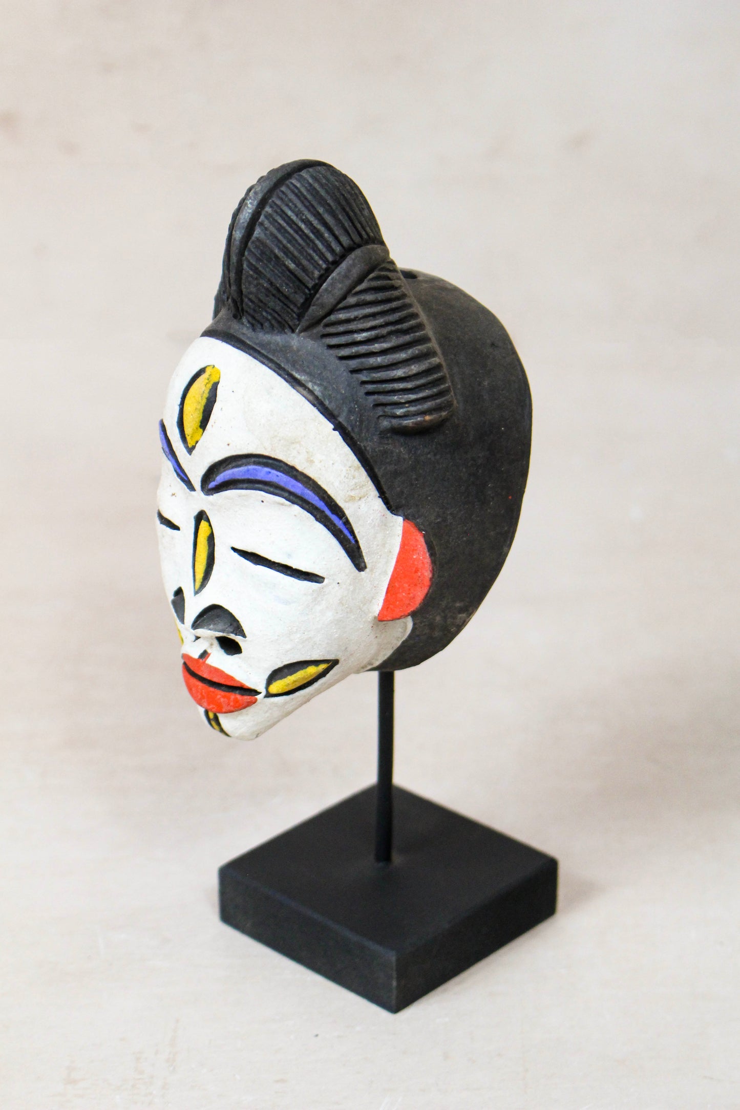 West African terracotta passport mask 189.2 in side view showing its sculptural profile and painted detail
