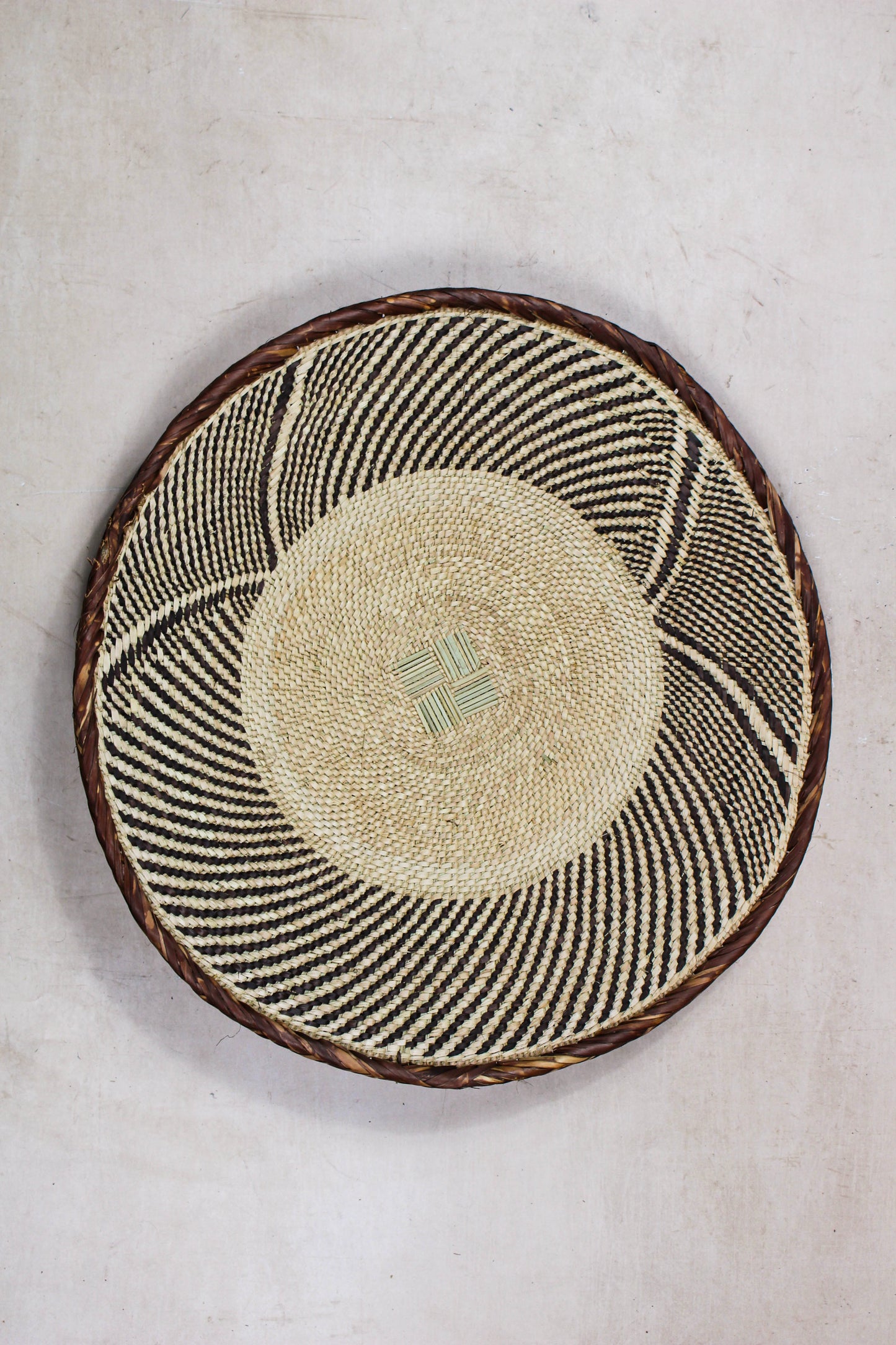 Handwoven Tonga basket from set No. 27 showing its natural circular woven pattern
