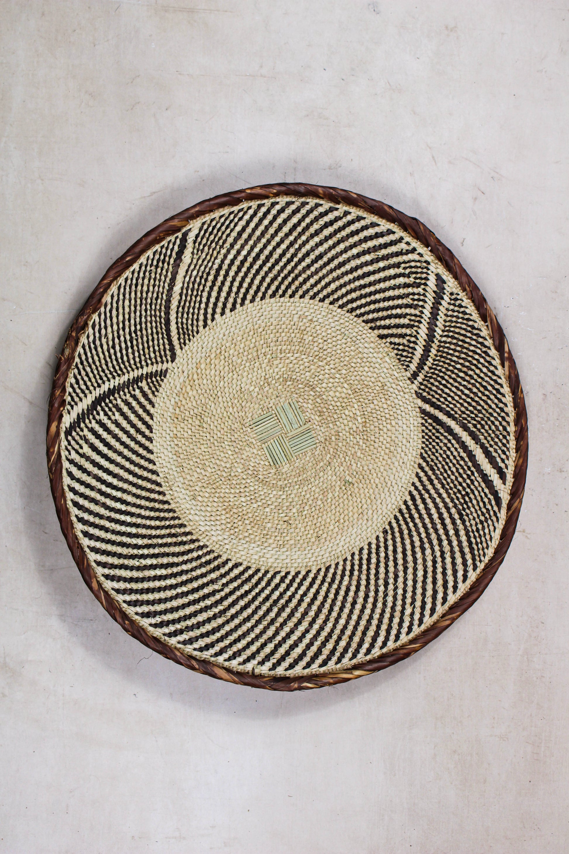 Handwoven Tonga basket from set No. 27 showing its natural circular woven pattern
