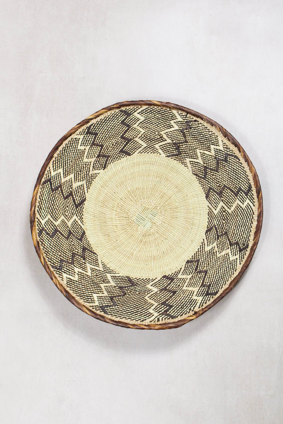 Handwoven Tonga wall basket from set No. 59 with natural geometric woven pattern

