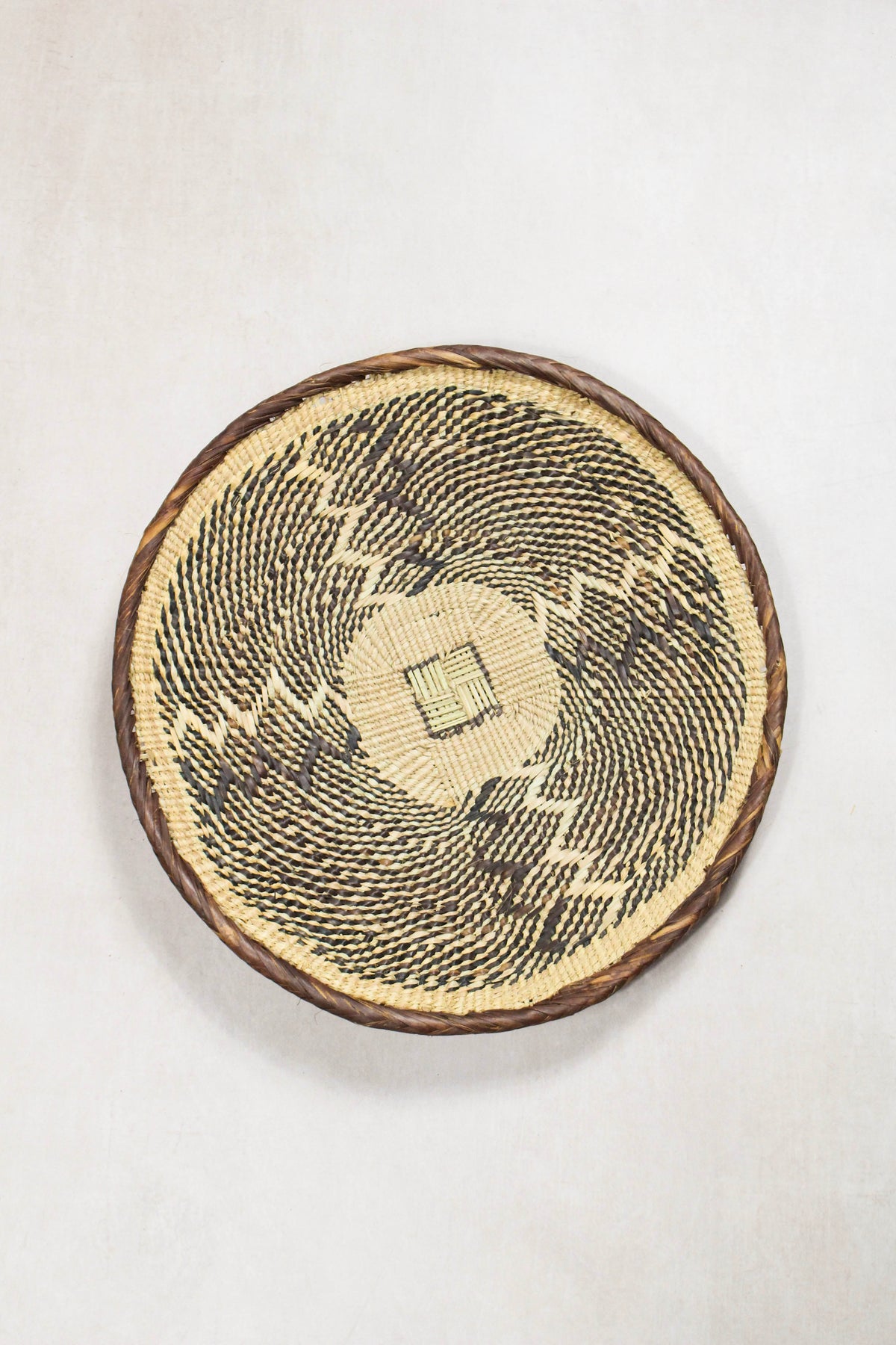 Handwoven Tonga wall basket from set No. 59 showing dark naturally dyed woven detailing
