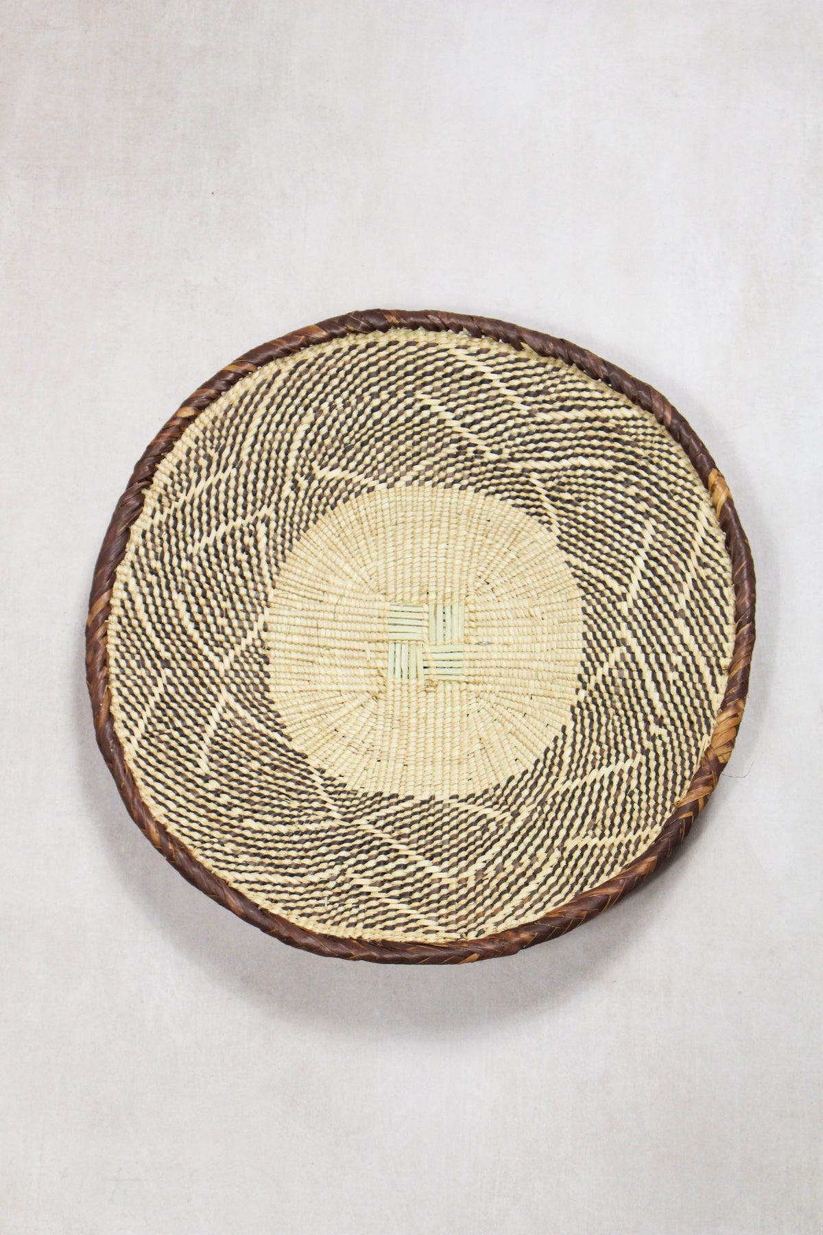 Handwoven Tonga wall basket from set No. 67 showing naturally dyed woven pattern