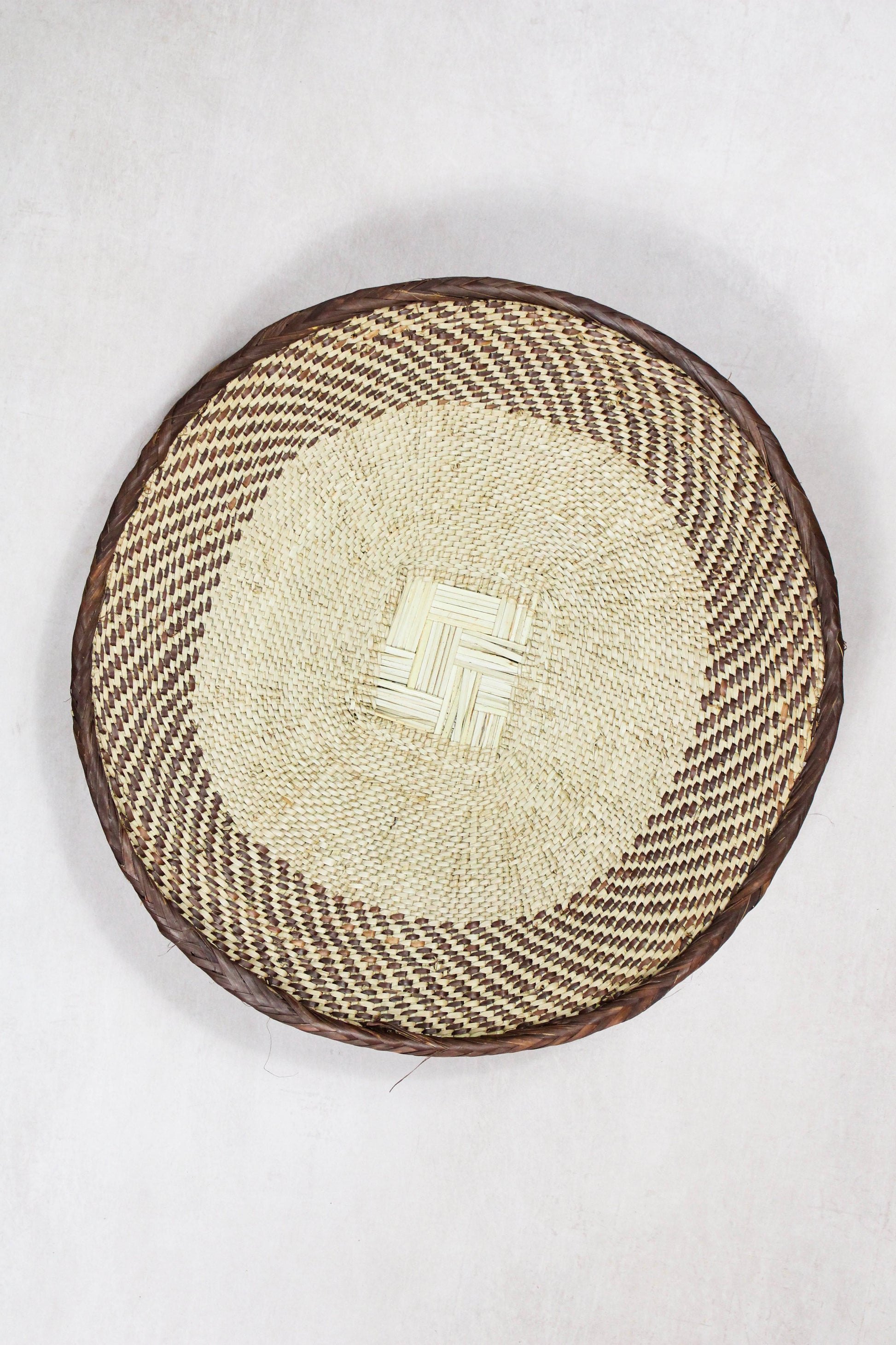 Handwoven Tonga wall basket from set No. 80 showing its individual circular woven pattern
