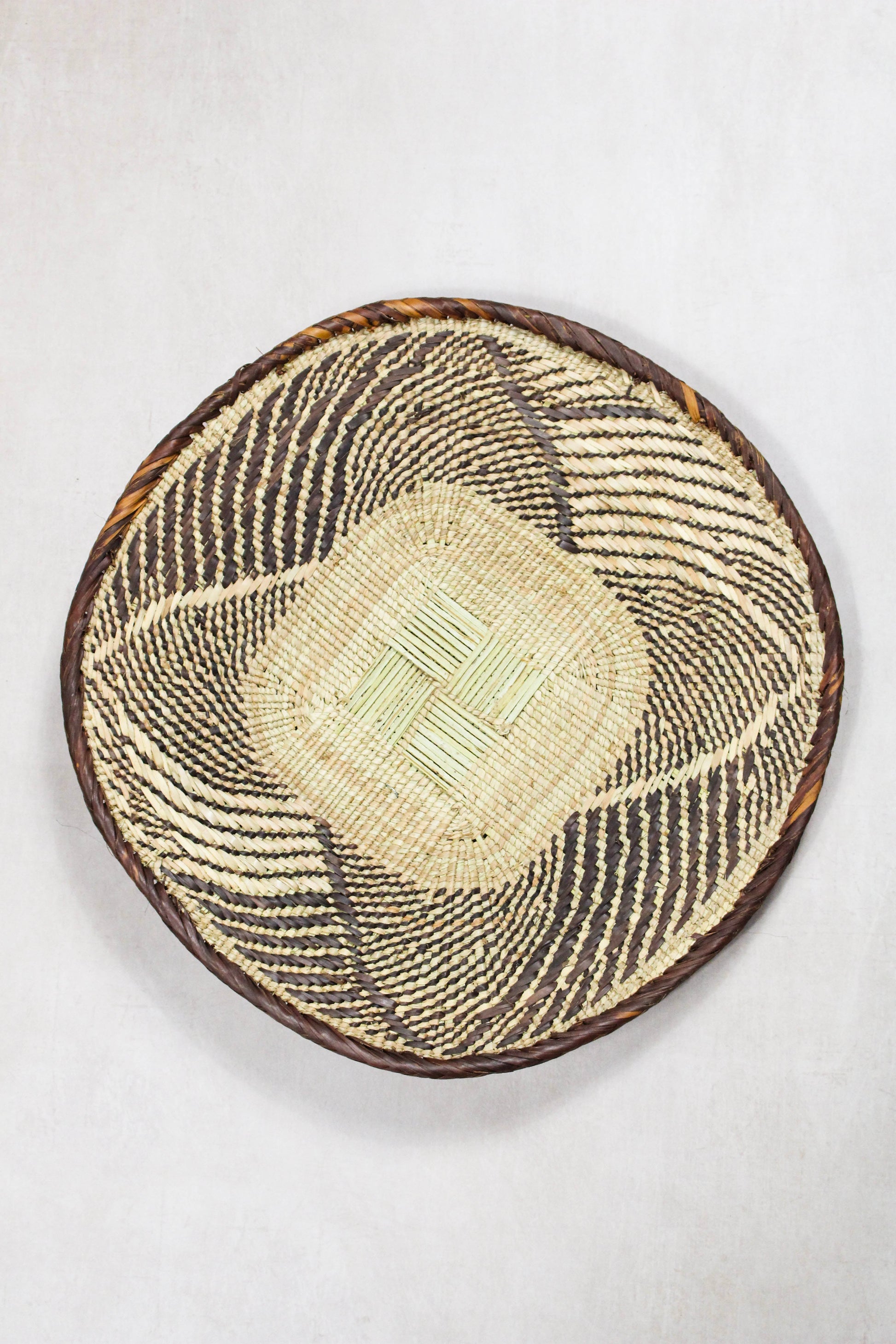 Handwoven Tonga wall basket from set No. 80 with naturally dyed geometric woven detailing